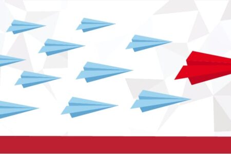 red origami plane leadiing light blue origami planes