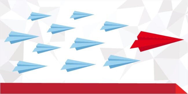 red origami plane leadiing light blue origami planes