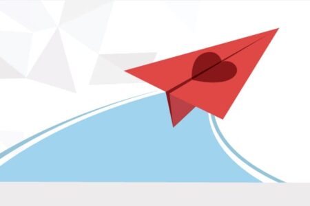 origami paper plane with a heart soaring to sky